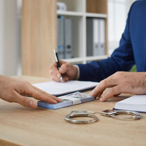 Attorney signing bail documents during a legal case review.