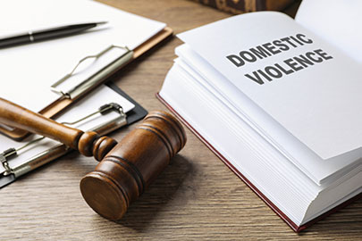 Legal gavel and law book on wooden desk representing rights after domestic violence case in Texas