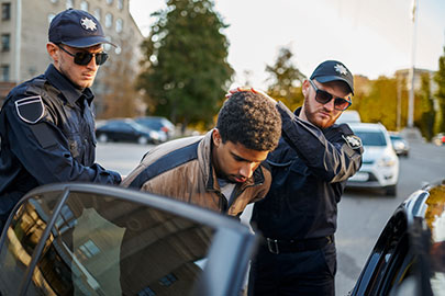 Alt Text: Man arrested and escorted to police car after DWI stop in Texas